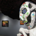 An image of a paper mache skull with Day of the Dead artwork painted on, from the Silver City Museum's curated show called "Arte Chicano"