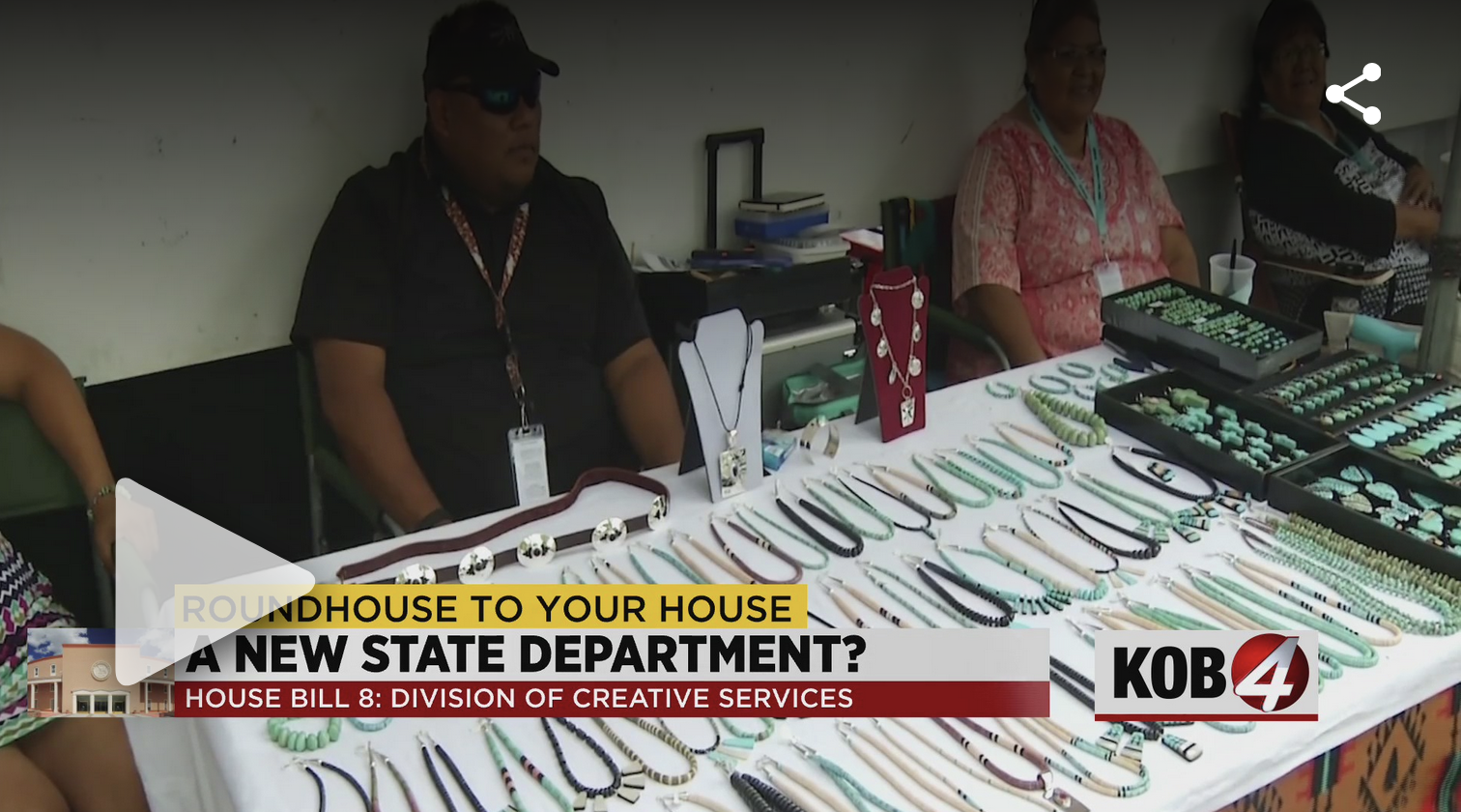 A screenshot of a video from KOB news, showing native jewelry artists selling their art. The video is about the new Creative Services division bill in New Mexico.
